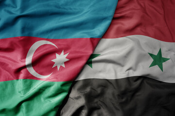 big waving national colorful flag of syria and national flag of azerbaijan.