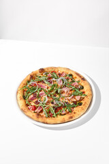 Gourmet tuna and olive pizza in nicoise style on a white background