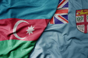 big waving national colorful flag of Fiji and national flag of azerbaijan.