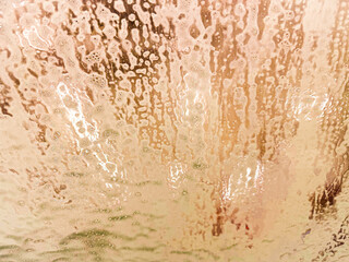 An art background in motion in gold, orange, and peach