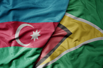 big waving national colorful flag of guyana and national flag of azerbaijan.