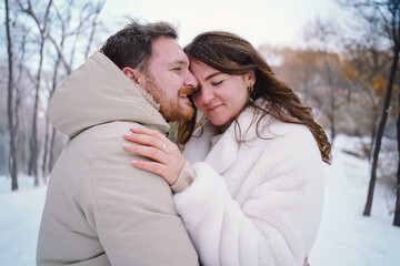 Fototapeta premium Loving couple on a snowy winter field. Happy together. Happy Valentine's Day