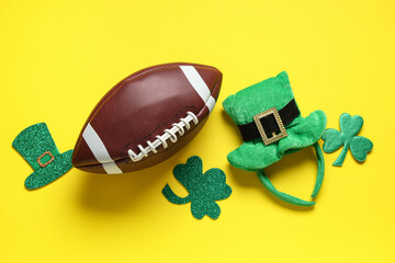 Rugby ball with leprechaun's hat and clovers on yellow background. St. Patrick's Day celebration