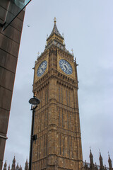Fototapeta na wymiar The Elizabeth Tower is the clock tower of the Palace of Westminster in London, Big Ben on a cloudy day. Westminster underground station.