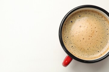 Cup of aromatic coffee on white table, top view. Space for text