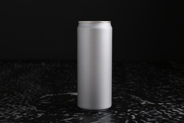 Energy drink in can on black textured table