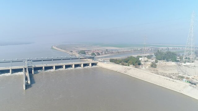 Aerial view of Head Taunsa Barrage is a barrage on the Indus River in Tehsil Taunsa, Dera Ghazi Khan District, Punjab Province, Pakistan. Where a lot of water is stored. Beautiful drone 4K view.