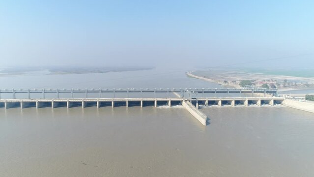 Aerial view of Head Taunsa Barrage is a barrage on the Indus River in Tehsil Taunsa, Dera Ghazi Khan District, Punjab Province, Pakistan. Where a lot of water is stored. Beautiful drone 4K view.