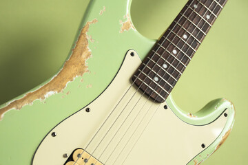 Old green electric guitar. Vintage background