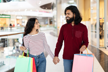 Happy Indian Couple Walking Hand In Hand By Mall