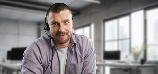 Technical support male operator working in office