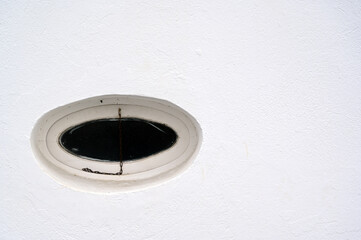 Oval window in a white wall