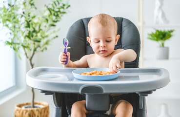 Little baby eating her dinner and making a mess