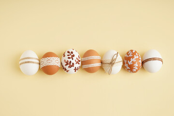 Decorated Easter eggs on beige background - obrazy, fototapety, plakaty