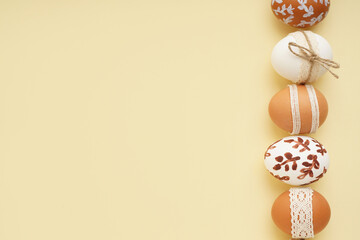 Composition with decorated Easter eggs on beige background