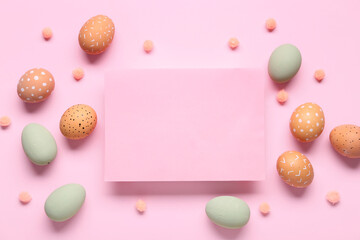 Easter eggs and blank card on pink background. Top view
