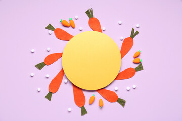 Easter paper carrots and blank greeting card on lilac background. Top view