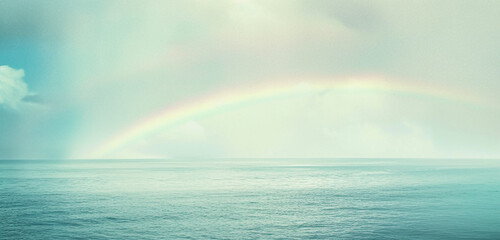 A serene depiction of a rainbow over a calm sea after the rain, symbolizing hope and renewal akin to the spirit of a festival with the sky transitioning from light grey to pale blue - obrazy, fototapety, plakaty