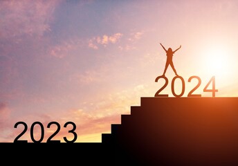 A man running on stairs to 2024 at sunset background