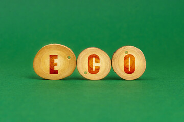 On a green background, wooden roundels with the inscription - ECO