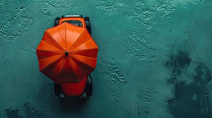 Dynamic top-down view featuring an automobile toy under an umbrella, symbolizing car insurance