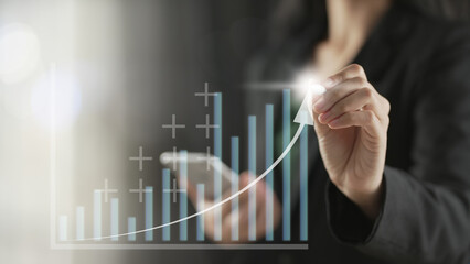 Hand holding growth business strategy arrow concept. Business development to success and growing growth concept, Businessman pointing arrow graph corporate future growth plan. growth and success.