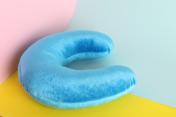 Light blue travel pillow on color background