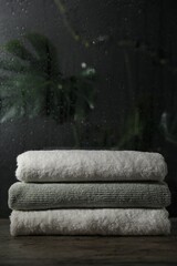 Stacked terry towels on table indoors, space for text