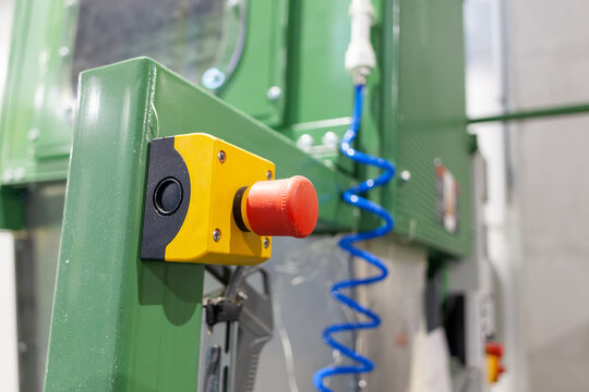 Close-Up of a Red Emergency Stop Button on Industrial Machinery