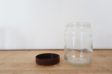 transparent empty glass jar on wooden counter