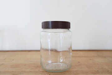 transparent empty glass jar on wooden counter