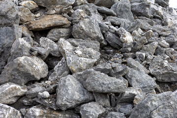 the wall of a mountain canyon made of natural material, limestone material of volcanic origin, close-up.