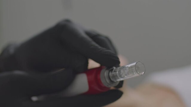 Close-up of device for procedure of needle mesotherapy into the skin of the face