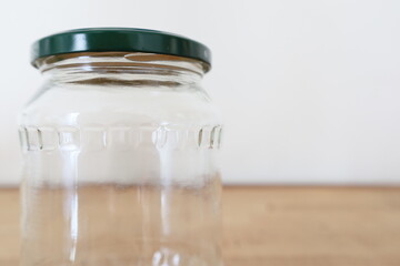 transparent empty glass jar on wooden counter