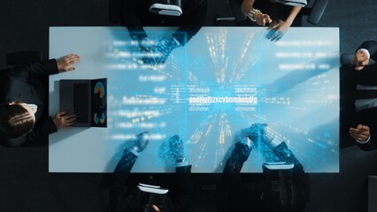 Top down aerial view of manager using laptop send data analysis while smart business team wear vr and working in metaverse or virtual program with hologram of coding engineering prompt. Directorate.