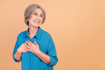 Portrait of appreciative pensioner person wear stylish shirt arms on chest look at sale empty space...