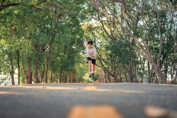 Attractive asian man running in the park on a background of trees with sunlight, Fitness Man Running for health, Training Run Workout, Motivation