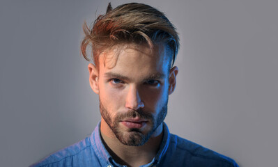 Closeup portrait bearded handsome businessman. Attractive unshaven man with stylish hairstyle in...