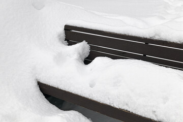Bench covered in snow after snowfall. Moscow, Russia