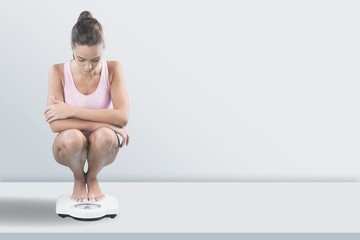 Woman legs on floor scales. Diet concept.
