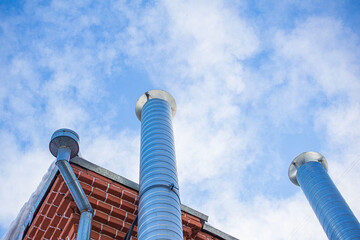 Metal chimney of a geothermal power station with stainless steel pipe structure with smoke and steam