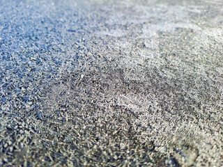 The surface of the cobblestones is covered with ice, icy conditions, black ice