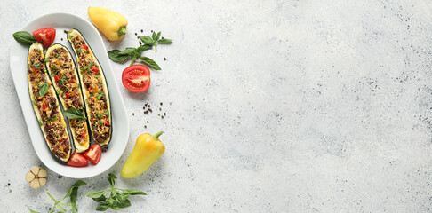 Meat stuffed zucchini boats on grunge background with space for text
