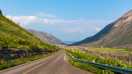 Road traverses through valley in Waterton Lakes National Park, Alberta, Canada