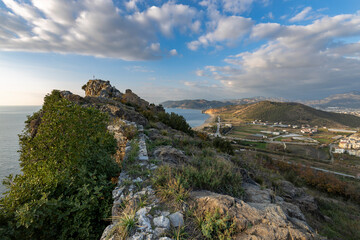 view from the ruins of the old town to the village near the sea, mountain and seascape
