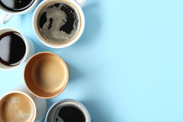 Cups of hot coffee on blue background