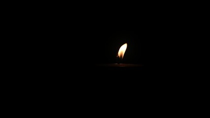 Closeup of burning flame on candle with isolated on black background. Candle flame in darkness. flame on black background.