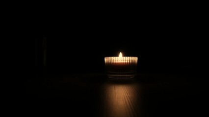 Closeup of burning flame on candle with isolated on black background. Candle flame in darkness....