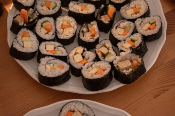 Fresh Homemade Sushi Roll against old wooden table.