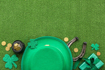 Pot with golden coins, horseshoe and leprechaun hat on grass. St. Patrick's Day celebration